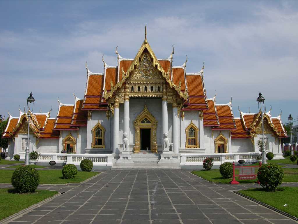 Bangkok 02 02 Wat Benchamabophit Marble Wat Long View Wat Benchamabophit, called the Marble Wat because of the white Carrara marble of which it's constructed, is an early-20C temple designed by Prince Narai, the half brother of Rama V. It's the most modern and one of the most beautiful of Bangkok's royal wats. Unlike the older complexes, there's no truly monumental wihaan or chedi dominating the grounds. Many smaller buildings reflect a melding of European materials and designs with traditional Thai religious architecture. Even the courtyards are paved with polished white marble.